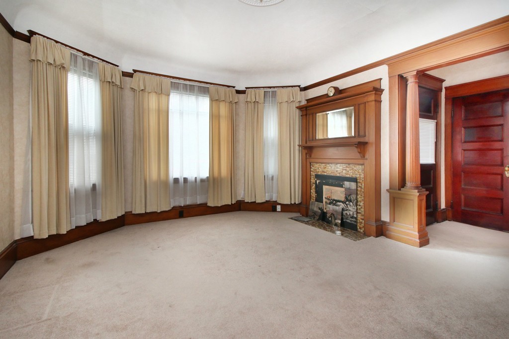 5 Pearson Road Somerville, MA 02144 - Photo 2 of 17 a view of an empty room with a fireplace and a window