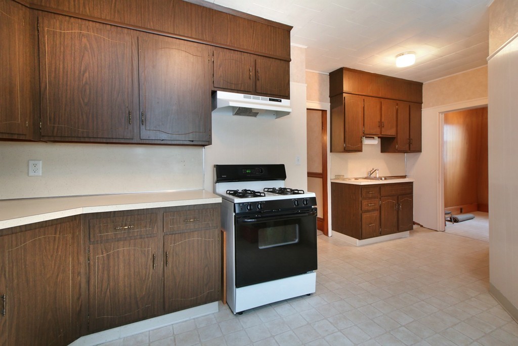 5 Pearson Road Somerville, MA 02144 - Photo 9 of 17 a kitchen with stainless steel appliances a stove a sink and a refrigerator