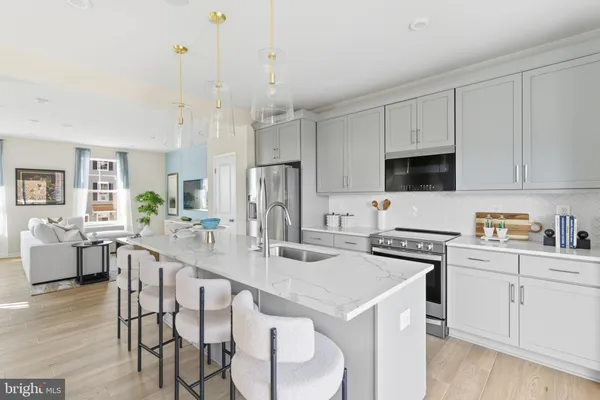 a kitchen with stainless steel appliances granite countertop a white cabinets and wooden floor