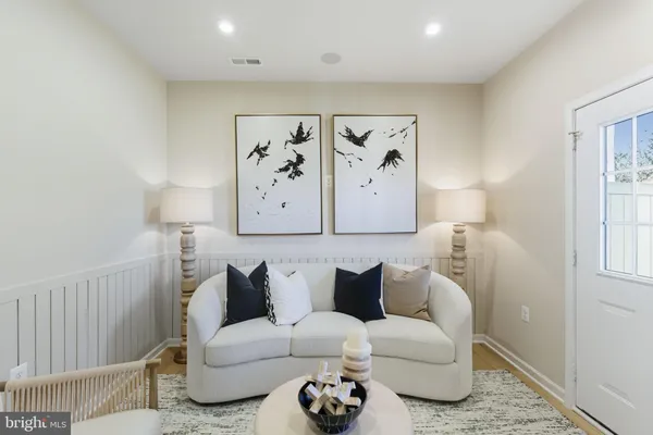 a living room with furniture and a painting