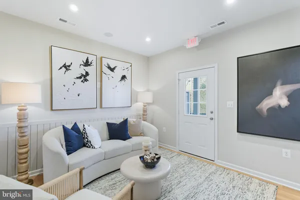 a living room with furniture and white walls