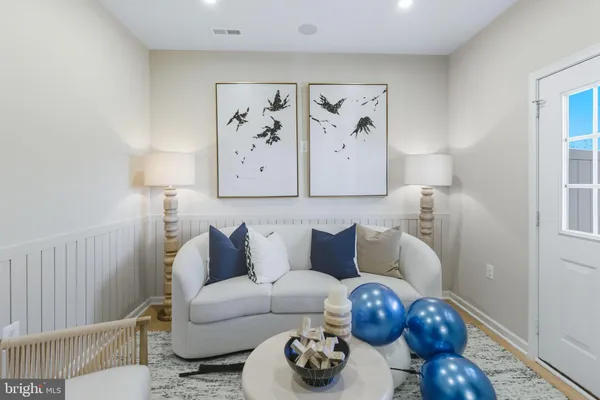 a living room with furniture and wall painting