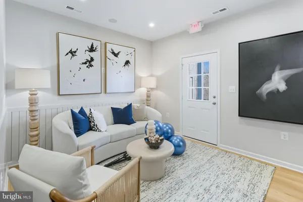 a living room with furniture and wall painting