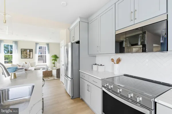 a kitchen with a sink appliances and cabinets