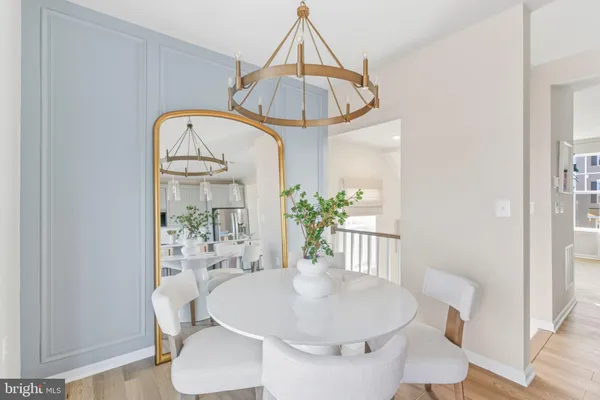 a dining room with furniture a rug and wooden floor