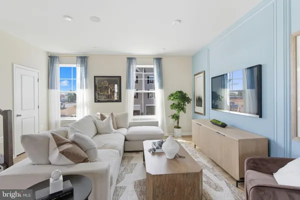 a living room with furniture and a potted plant