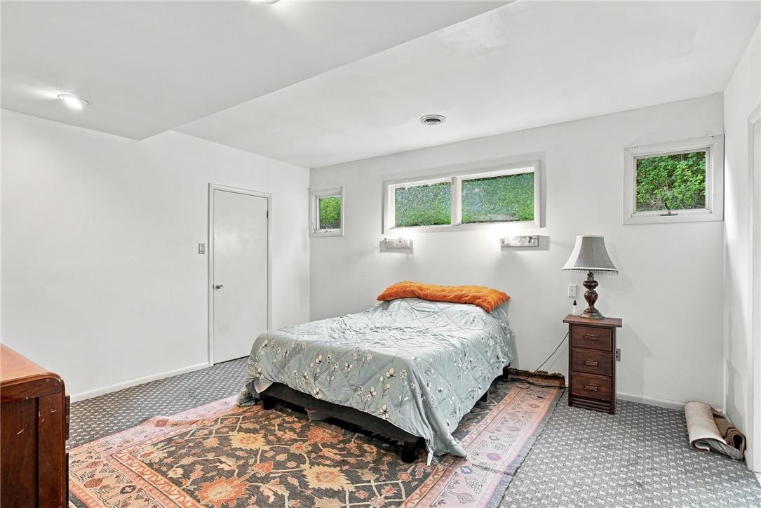 3408 Oak Hill Road Emmaus, PA 18049 - Photo 25 of 93 High windows invite natural light into this quiet lower level bedroom with patterned flooring.