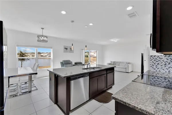 a kitchen with granite countertop a sink and cabinets