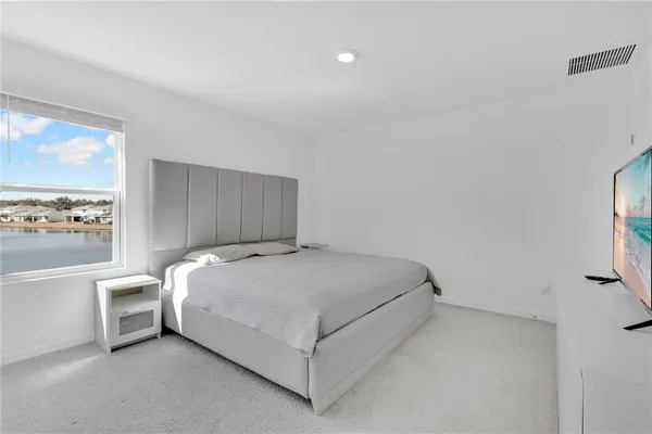 a bedroom with a bed and a large window