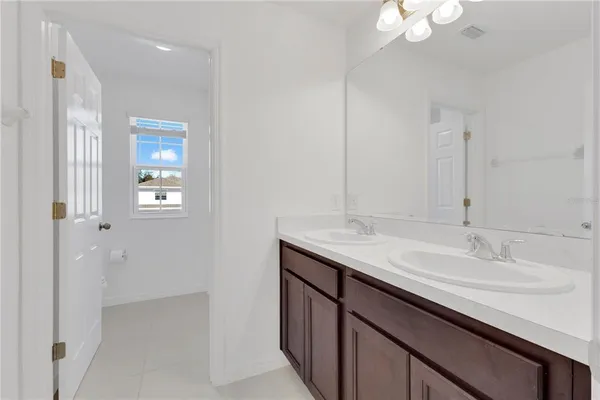 a bathroom with a sink double vanity and a mirror
