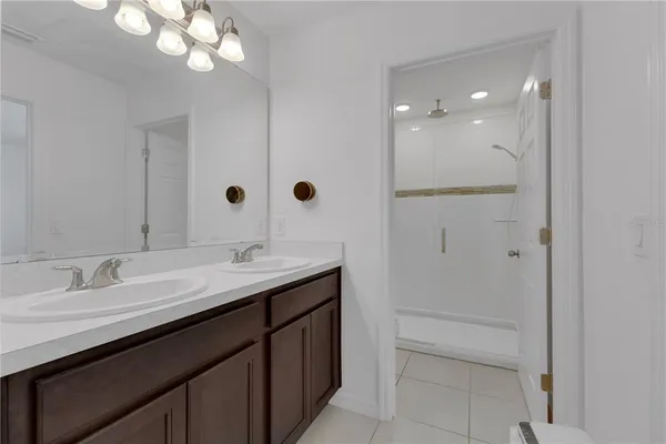 a bathroom with a double vanity sink and a mirror