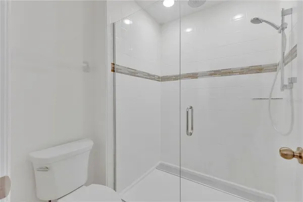 a bathroom with a shower and a toilet