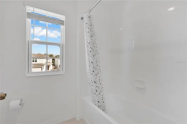 a bathroom with a bathtub and shower