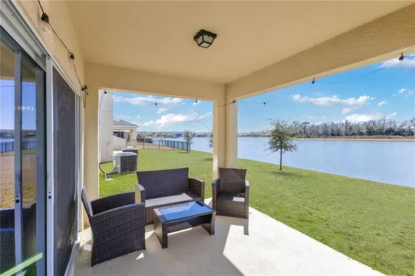 a view of a patio with swimming pool and furniture