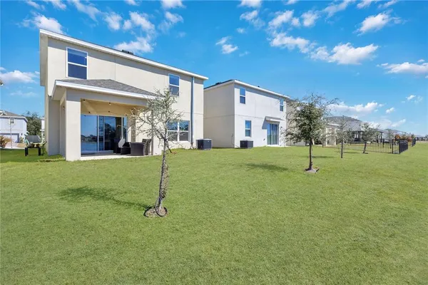 a view of a house with a backyard