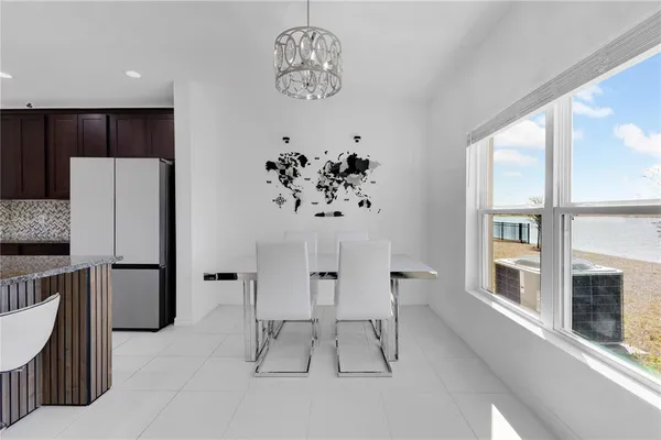 a view of kitchen with furniture and refrigerator
