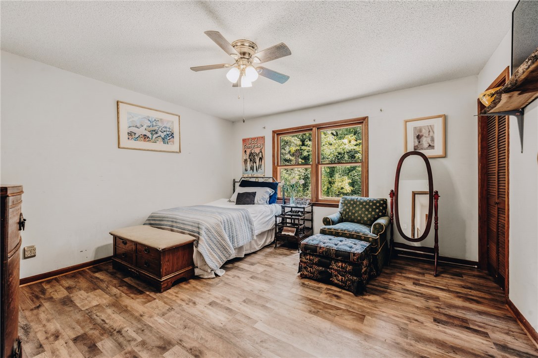 707 Campbell Town Road Walhalla, SC 29691 - Photo 15 of 44 Rich wood-look flooring and wood-framed windows bring natural warmth to this comfortable bedroom space.