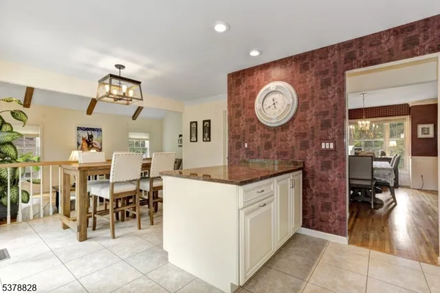 a living room with furniture a clock and a view of dining table