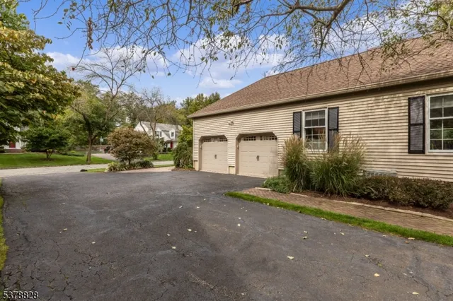 a view of a house with a yard and garage