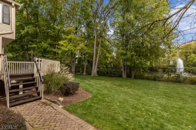 a view of a deck in front of house with trees
