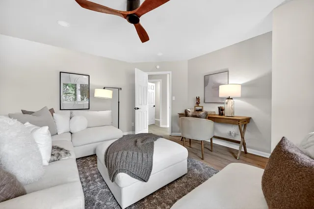 a living room with furniture and a lamp