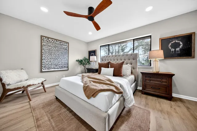 a bedroom with a large bed and a window