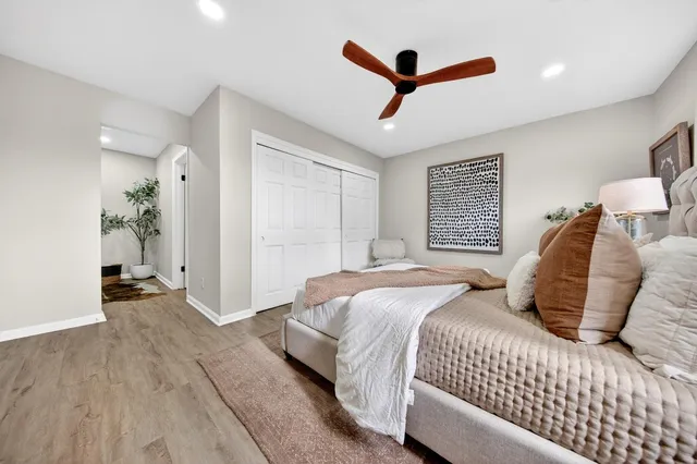 a bedroom with a large bed and a ceiling fan
