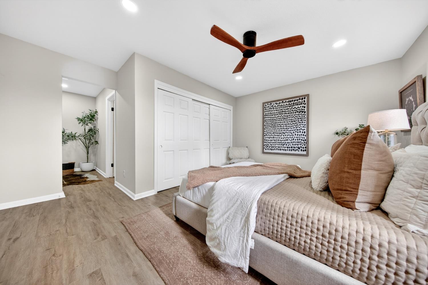 16947 Patricia Way Grass Valley, CA 95949 - Photo 16 of 50 a bedroom with a large bed and a ceiling fan