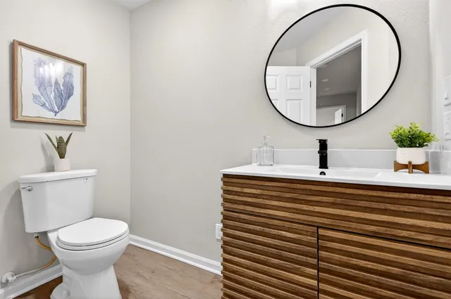 a bathroom with a sink a mirror and a toilet