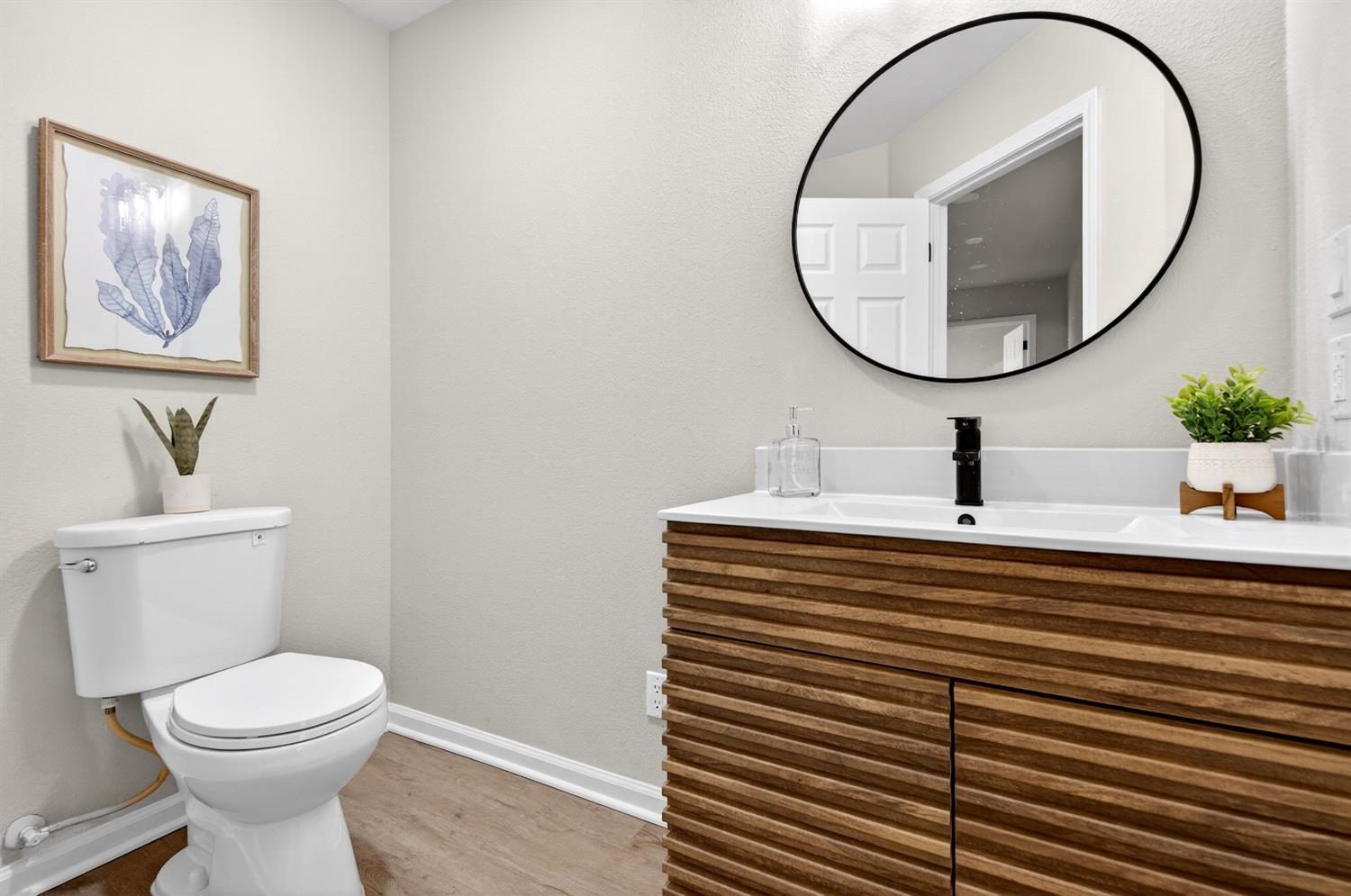 16947 Patricia Way Grass Valley, CA 95949 - Photo 20 of 50 a bathroom with a sink a mirror and a toilet
