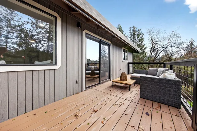 a balcony with furniture and wooden floor