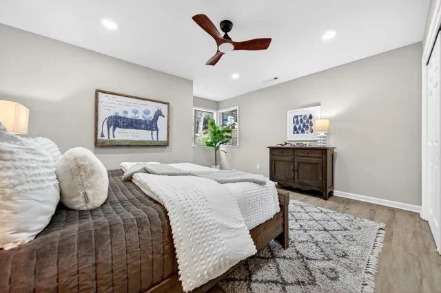a spacious bedroom with a bed and a chandelier