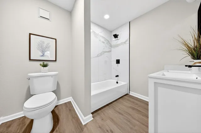 a bathroom with a toilet sink and shower