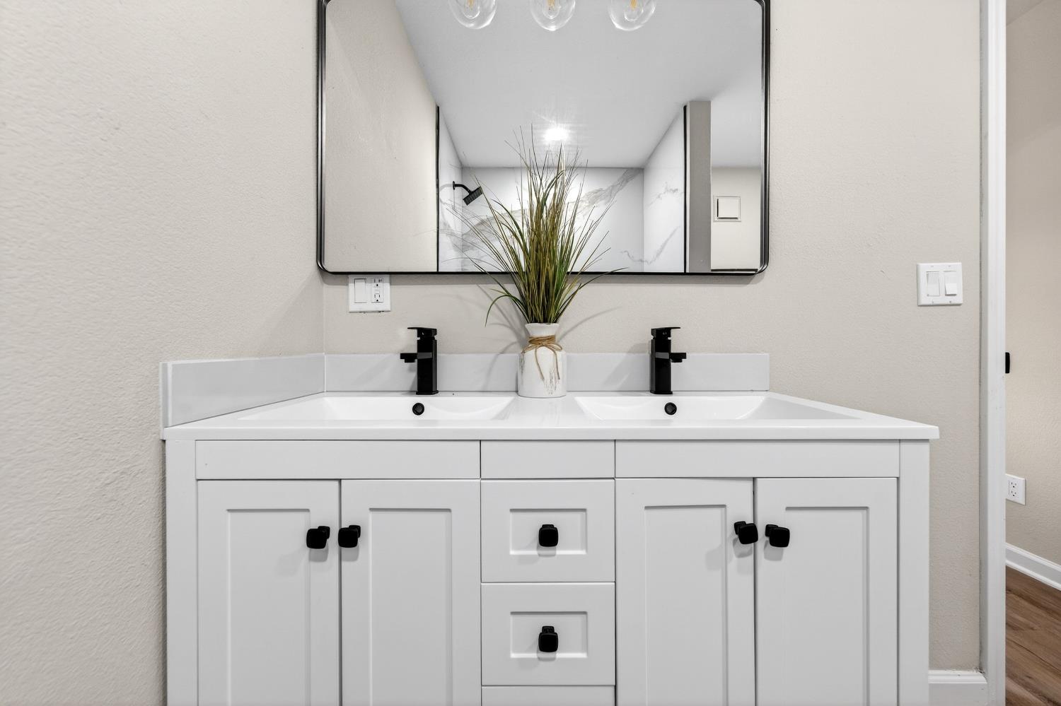 16947 Patricia Way Grass Valley, CA 95949 - Photo 28 of 50 a bathroom with double vanity sink a mirror and shower