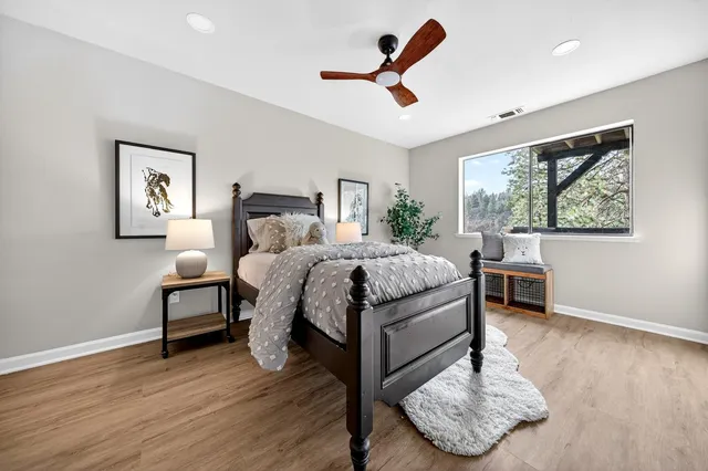a bedroom with a bed and wooden floor
