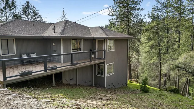 a view of a house with roof deck and wooden fence