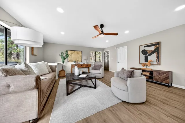 a living room with furniture and a wooden floor