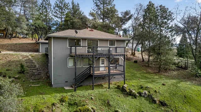 a backyard of a house with yard and outdoor seating