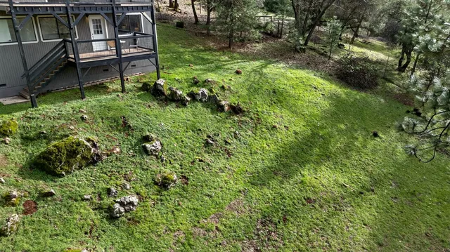 a backyard of a house with table and chairs