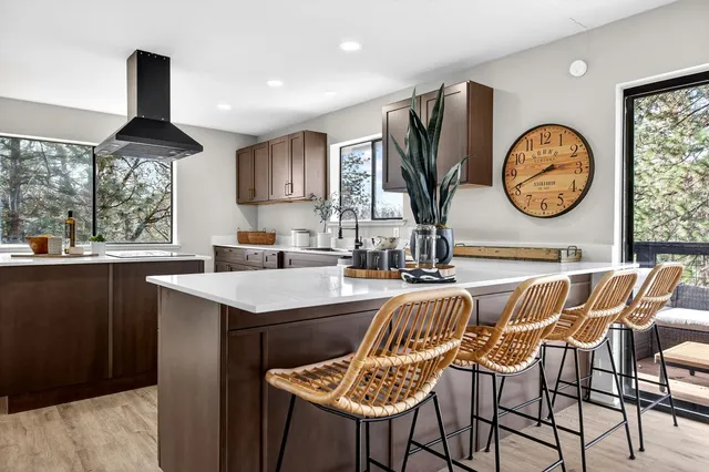 a living room with furniture a window and a clock