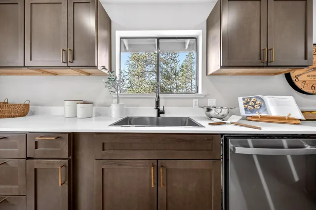 a kitchen with a sink cabinets and window