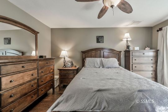 1267 North Erwin Street Ridgecrest, CA 93555 - Photo 17 of 35 a bedroom with a bed and ceiling fan