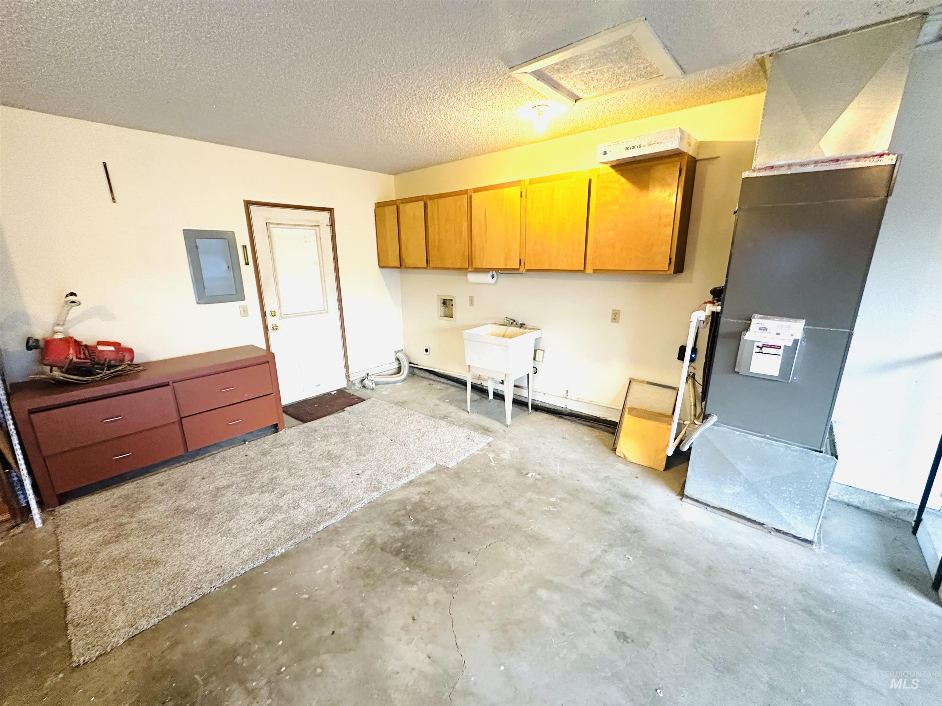 1111 West D Street Vale, OR 97918 - Photo 22 of 26 Garage featuring electric panel and heating unit
