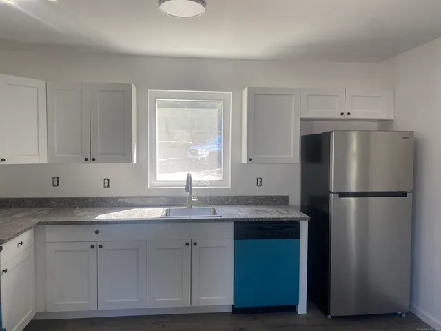 a kitchen with appliances cabinets and a sink