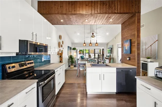 a kitchen with stainless steel appliances granite countertop a stove and a sink