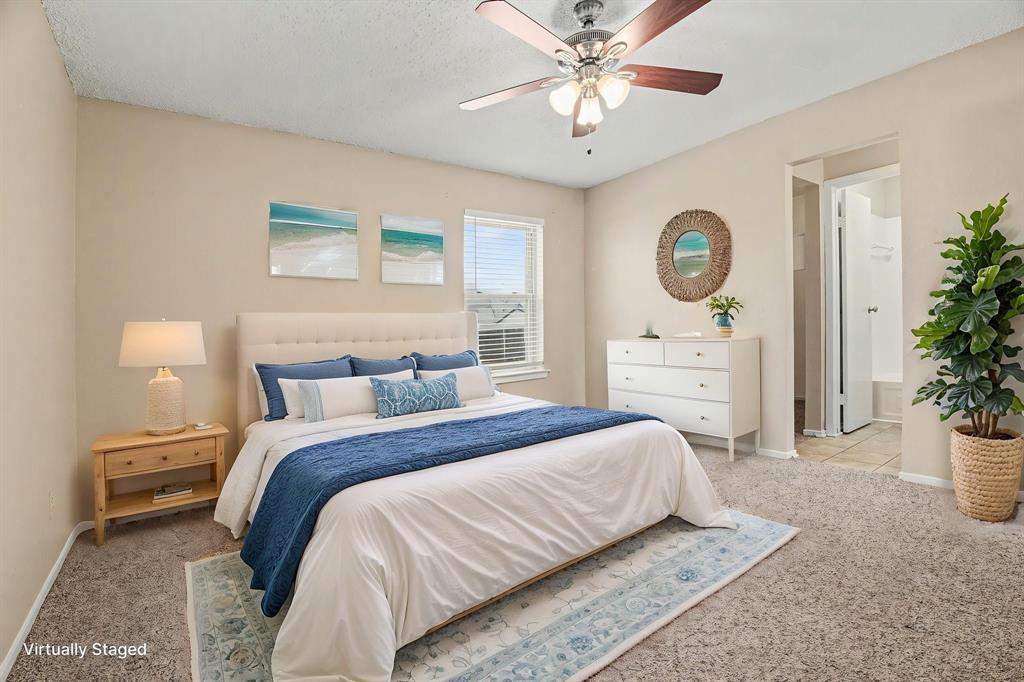 1024 South Riverside Drive Grapevine, TX 76051 - Photo 12 of 21 a bedroom with a bed a potted plant and a closet