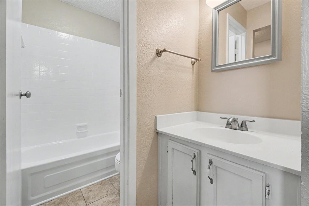 1024 South Riverside Drive Grapevine, TX 76051 - Photo 13 of 21 a bathroom with a sink and a bathtub