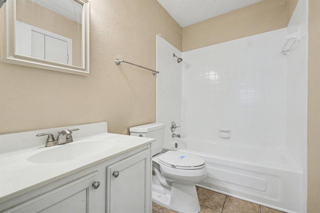 1024 South Riverside Drive Grapevine, TX 76051 - Photo 15 of 21 a bathroom with a sink a toilet and shower