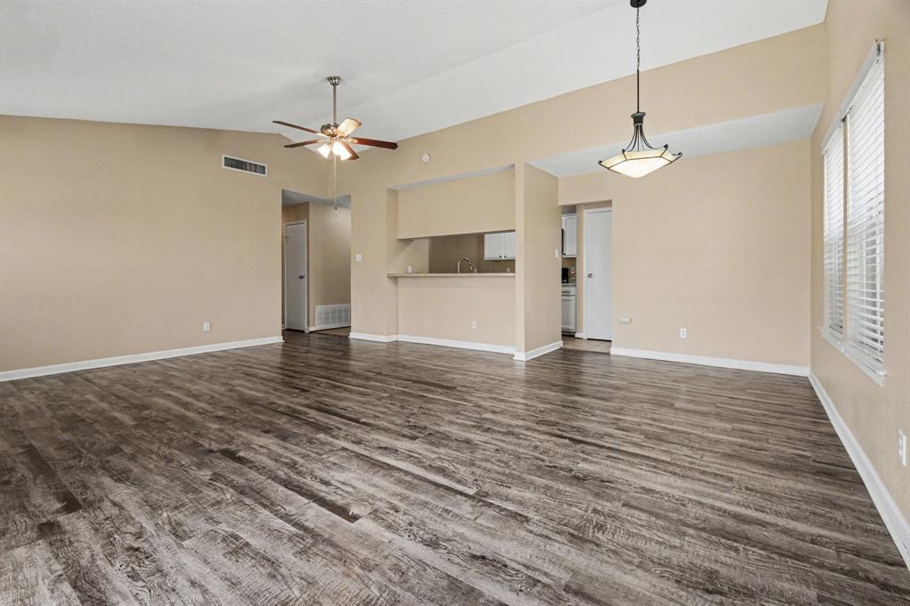 1024 South Riverside Drive Grapevine, TX 76051 - Photo 6 of 21 a view of a livingroom with a ceiling fan window and wooden floor