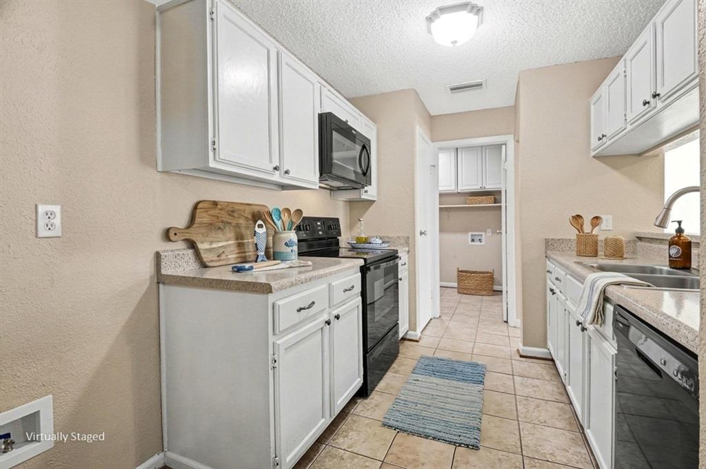 1024 South Riverside Drive Grapevine, TX 76051 - Photo 9 of 21 a kitchen with stainless steel appliances granite countertop a sink and dishwasher a stove top oven with white cabinets